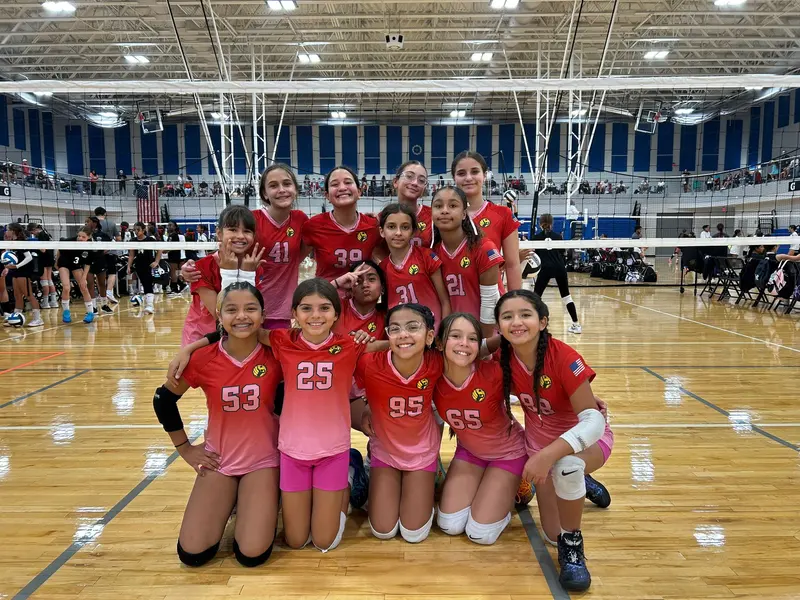 Competitive team in red and pink jerseys at a national tournament